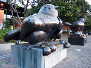 Botero Bird Sculpture destroyed by a bomb attack, replica sculpture in the background - both a reminder of the history of Medellin