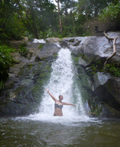 Swimming in a remote waterfall in the jungle