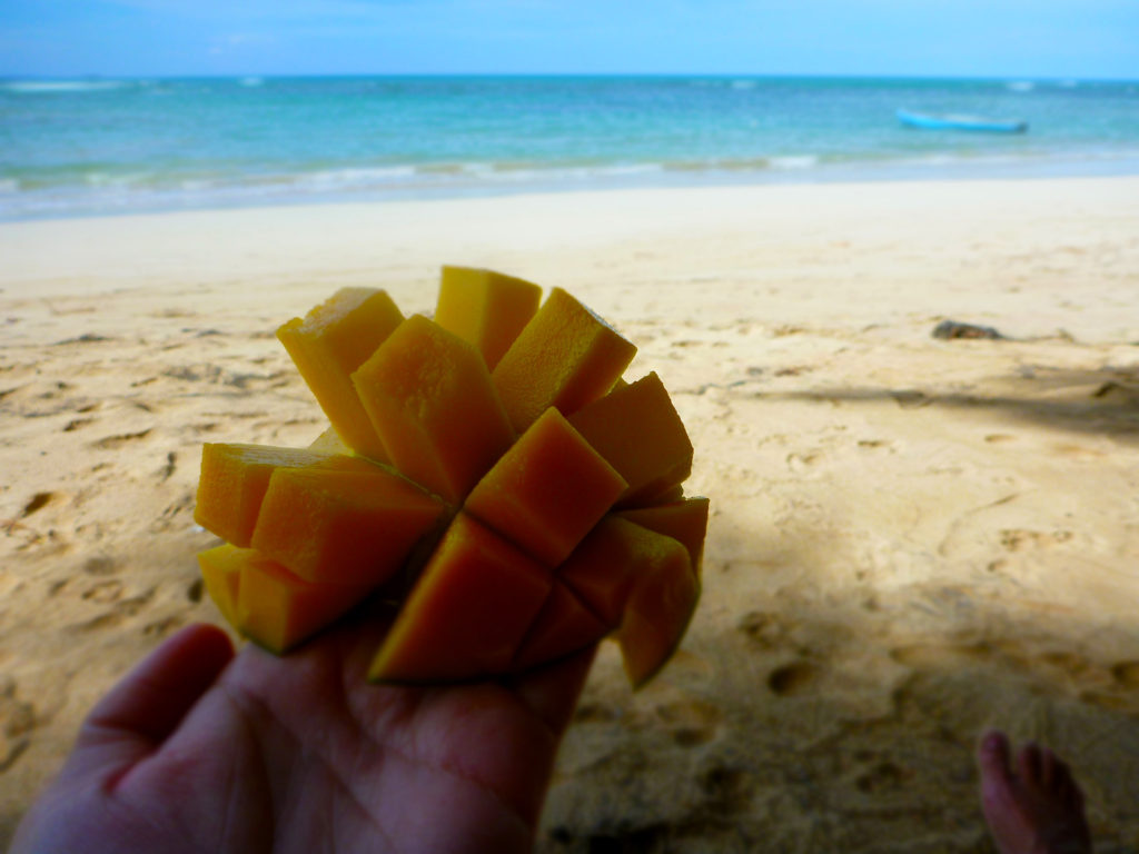 Eating fresh mango on the beach, Playa de las Ballenas